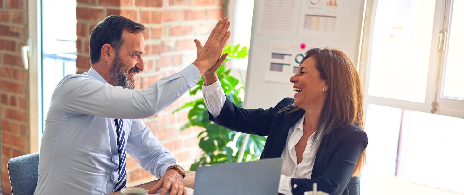 business owners doing a high five due to Find Net Solutions effective website site solutions